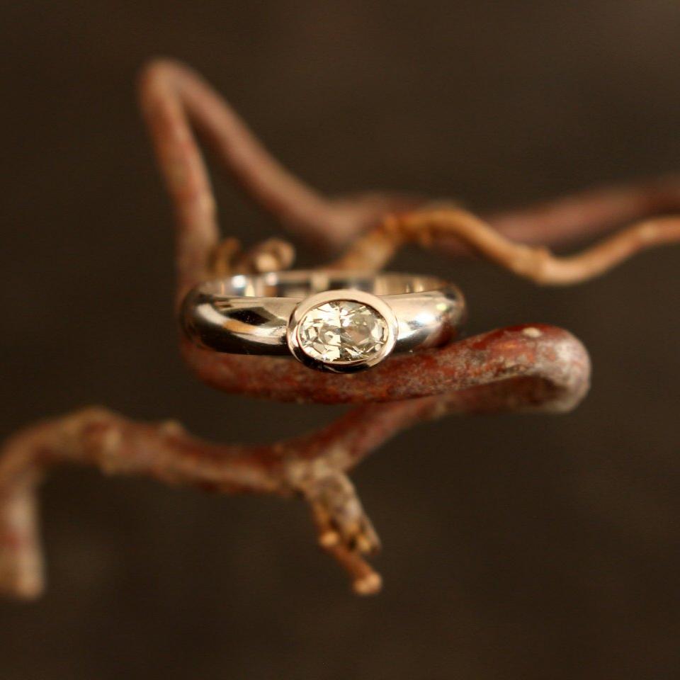 white gold ring with colorless sapphire