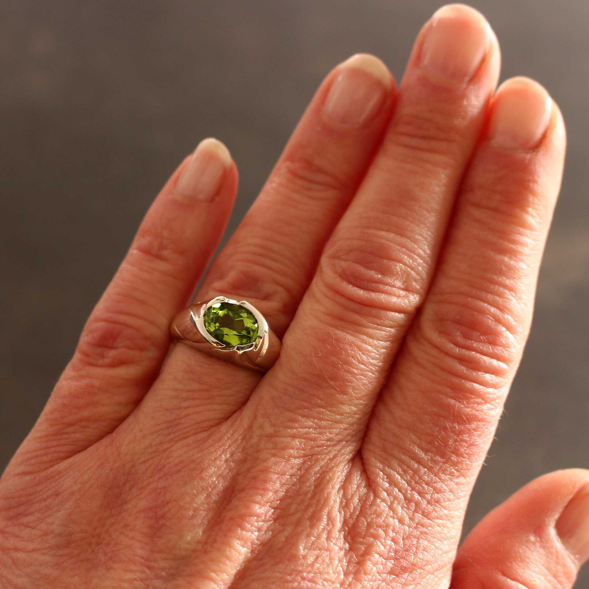 silver ring floral with peridot