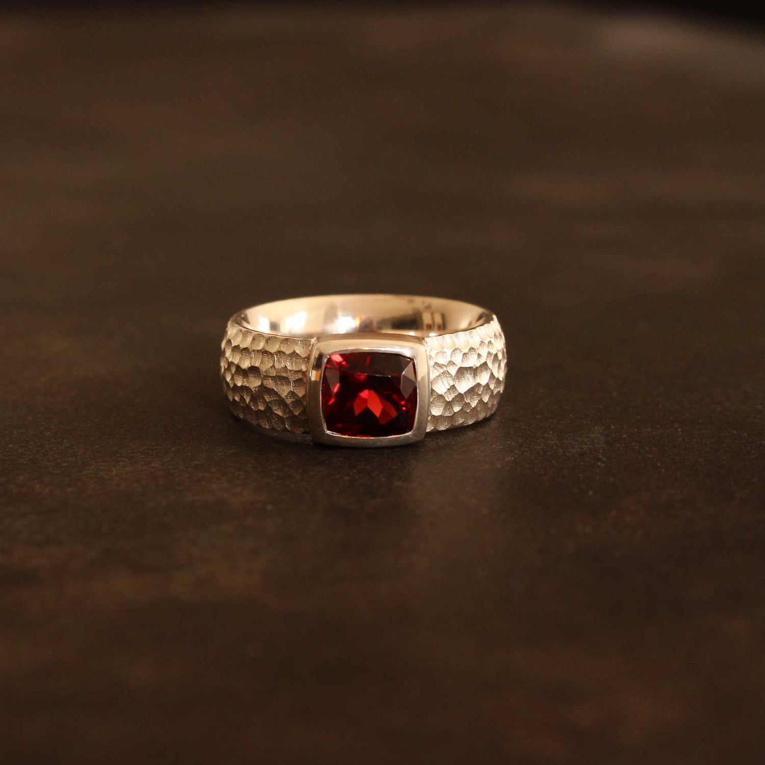 Silver ring with faceted antique cut garnet