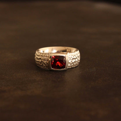 Silver ring with faceted antique cut garnet